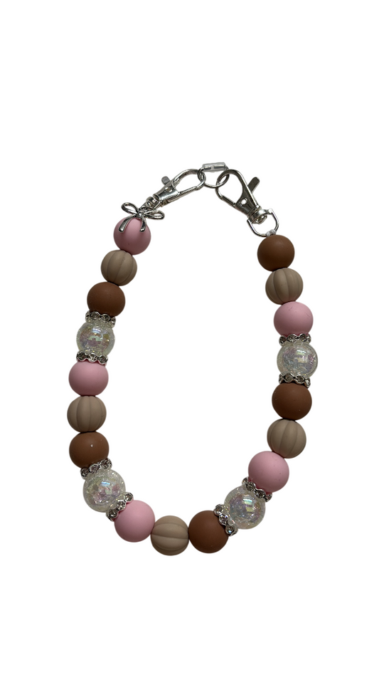 Telefoonketting (pols) beige/roze met bedelstrikje
