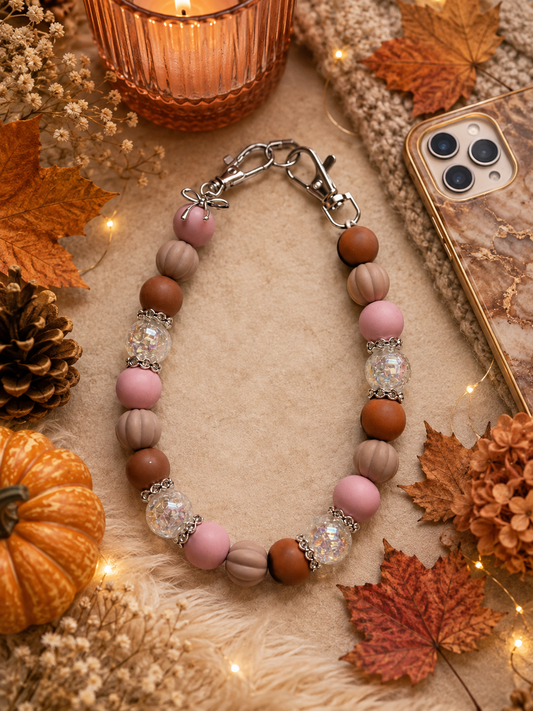 Telefoonketting (pols) beige/roze met bedelstrikje