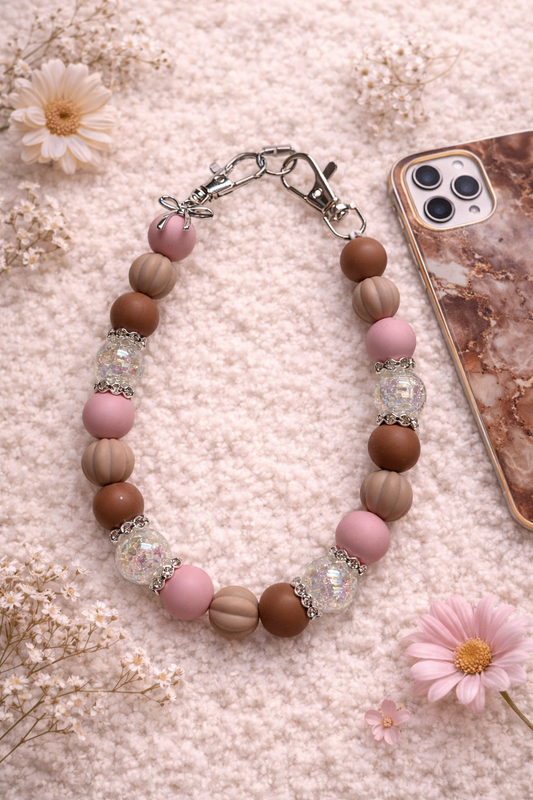 Telefoonketting (pols) beige/roze met bedelstrikje